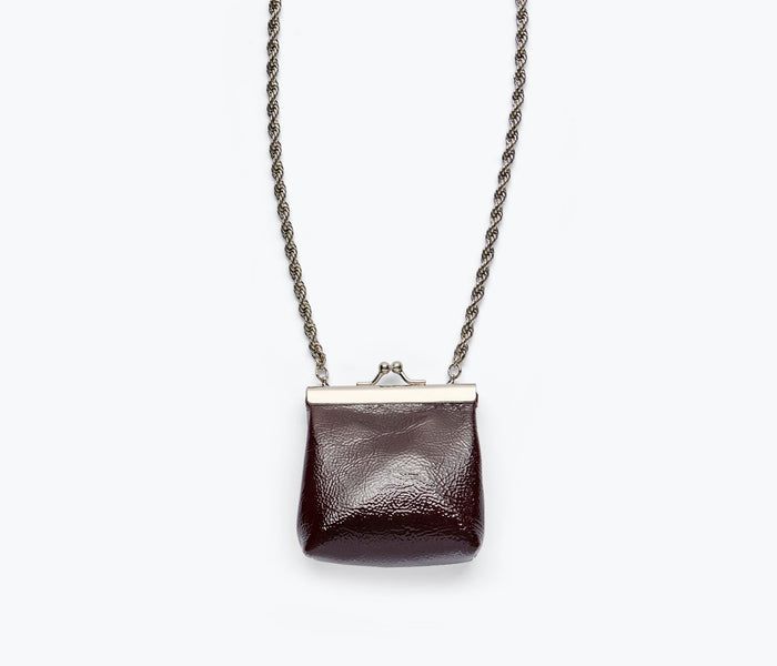 Fredas Salvador Kenzo mini purse necklace featuring a wine-colored crinkle patent bag with a sleek, stylish design.