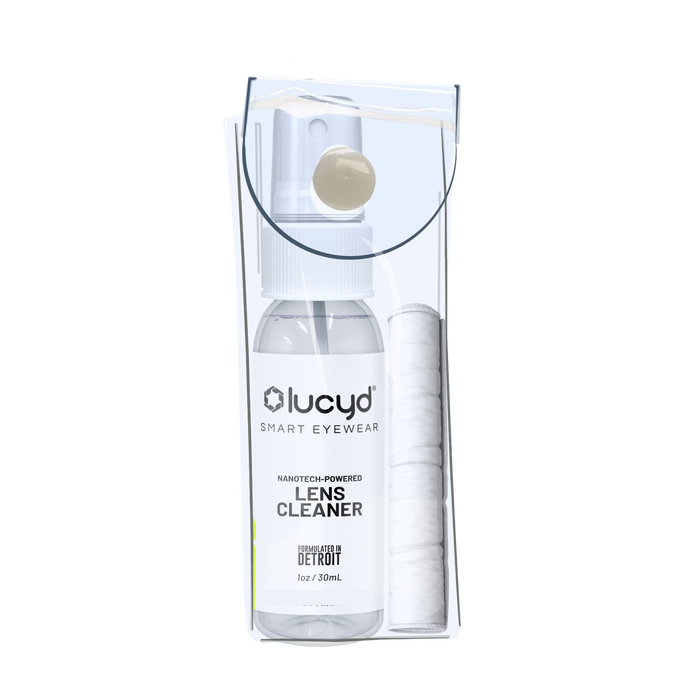 Clear plastic package with a 1oz Lucyd Lens Cleaning Kit—includes spray bottle and rolled white cloth—shown against a plain light background.
