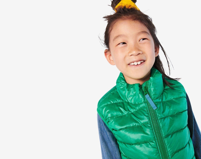 Child wearing Primary - Lightweight Puffer Vest - Green Bean - Available at www.tenlittle.com