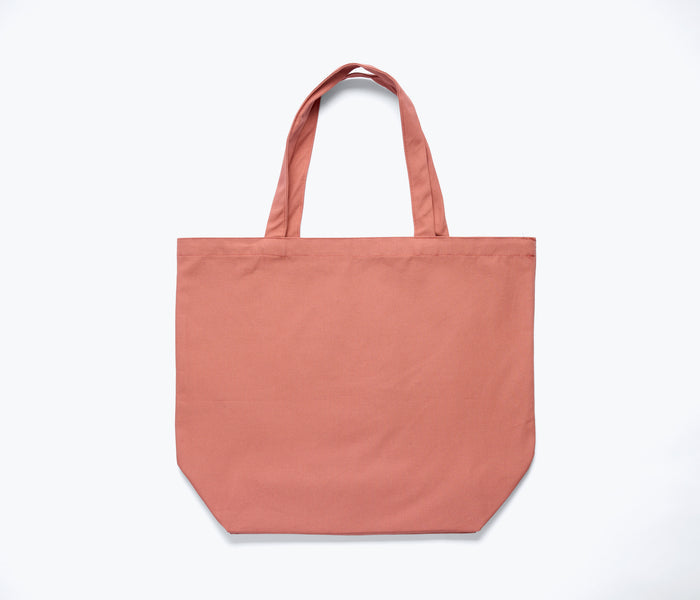 Limited edition Freda Salvador illustrated tote bag in dusty rose with detailed marketing material design on the back.