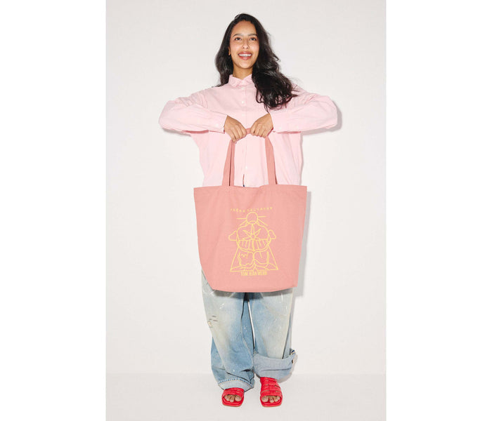 Limited edition illustrated dusty rose tote bag by Freda Salvador, showcasing detailed artwork on durable marketing material.