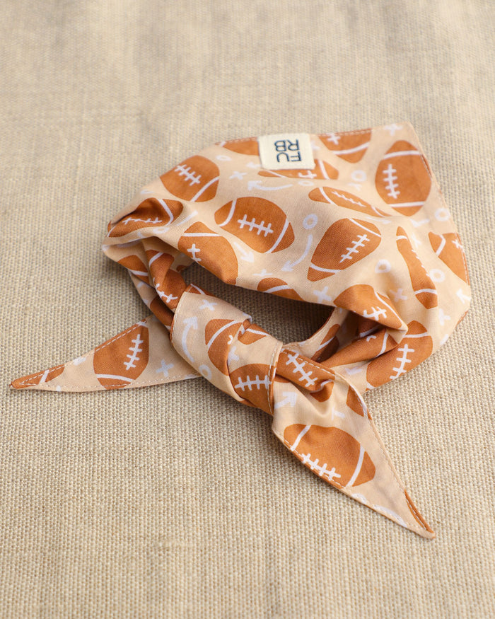 Football print dog bandana made from durable cotton with an adorable sporty design for small to medium breed dogs