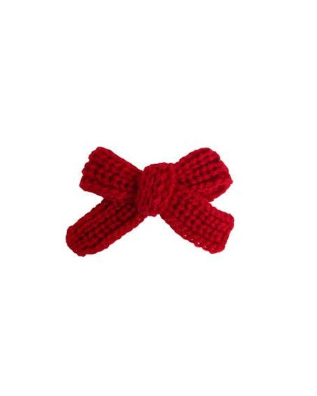 Dog wearing Little Darling red, white, and blue hair bow for holiday celebrations.