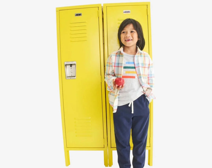 Child at locker wearing Primary Long Sleeve Button Down - Rainbow Flannel - Marshmallow / Rainbow Plaid. Available at www.tenlittle.com