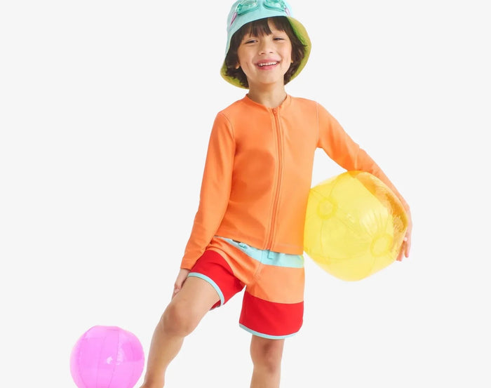 Child wearing Primary Long Sleeve Full-Zip Rash Guard - Cantaloupe. Available at www.tenlittle.com