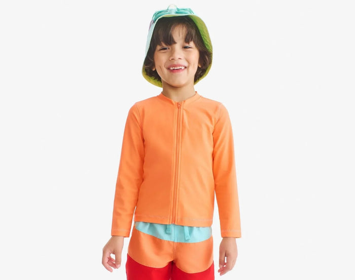 Child wearing Primary Long Sleeve Full-Zip Rash Guard - Cantaloupe. Available at www.tenlittle.com