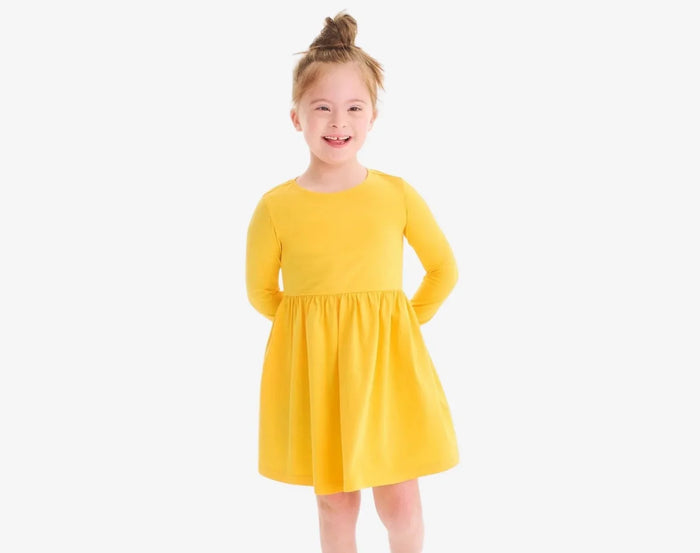 Child wearing Primary Long Sleeve Pocket Dress - Sunflower. Available at www.tenlittle.com