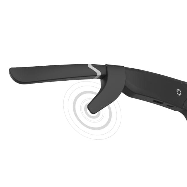 A close-up of the arm of a pair of Lucyd smart glasses showcases the Lucyd Boosters for Lucyd Armor & Reebok Sport, with sound waves near the hinge suggesting integrated audio or bone conduction features. The sleek black frame, marked by a geometric logo, highlights how these advanced sound amplifiers from Lucyd are seamlessly integrated to deliver an enhanced listening experience.