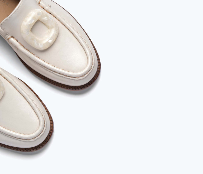 Freda Salvador Mateo resin penny loafer in bone calf leather with detailed stitching and classic slip-on design.