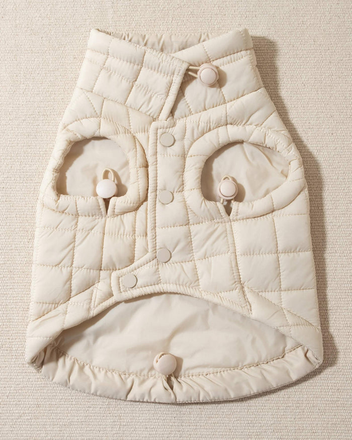 perfect on its own or layered with a cute sweater. This quilted, stylish jacket is fully adjustable, with coordinating sand cords on the hem, neck, and arm openings. Jacket can be worn over harness, with a small opening for leash attachment on the back. Asymmetrical buttons also make for more secure wear, for even the most portly of pups!. frenchie dog puppy jackets