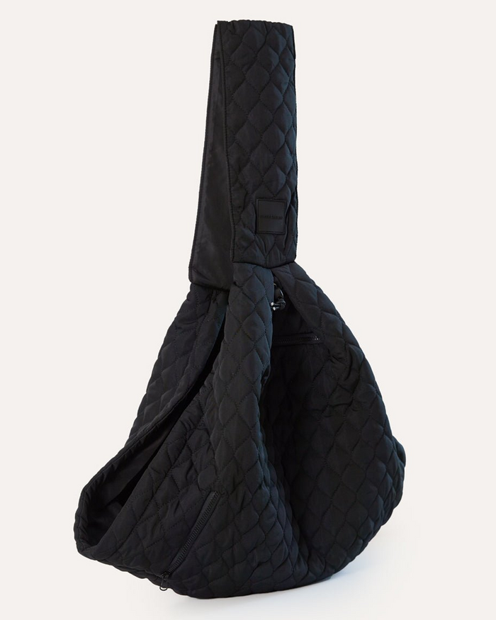 Eco-friendly black pet sling made with recycled nylon and water bottles, designed for small dogs up to 10 pounds