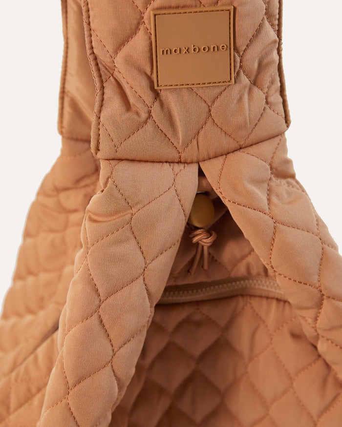Recycled nylon camel dog carrier sling that packs into a convenient pouch for small dogs up to 10 pounds