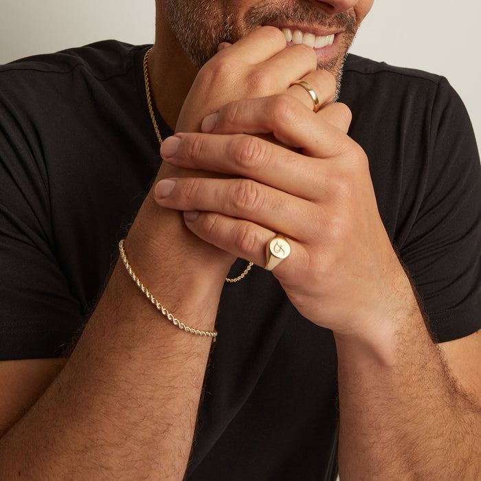 Model. Man wearing gold rings and chains