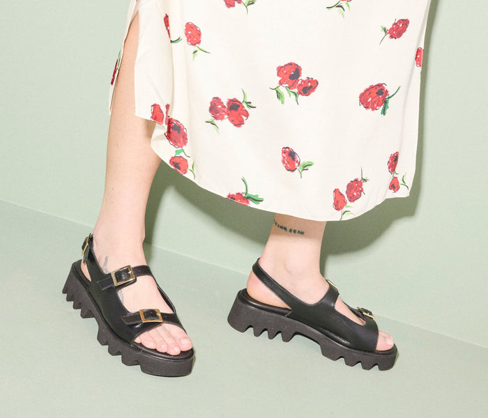 Black Freda Salvador Mindy Lug Sole Sandal with chunky sole and strappy design, shown from a side angle on a neutral background.