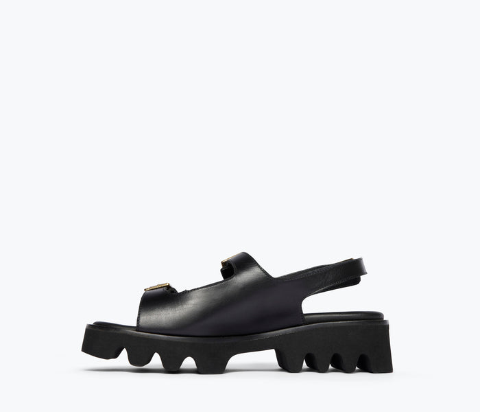 Black Mindy Lug Sole Sandal by Freda Salvador, showing the inside view with cushioned footbed and chunky sole.