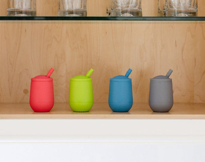 ezpz Mini Cup & Straw in blue and 3 other colors inside cabinet. Available at tenlittle.com