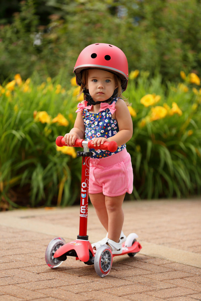 Child riding Micro Kickboard Mini Deluxe LED Scooter - Red. Available at www.tenlittle.com