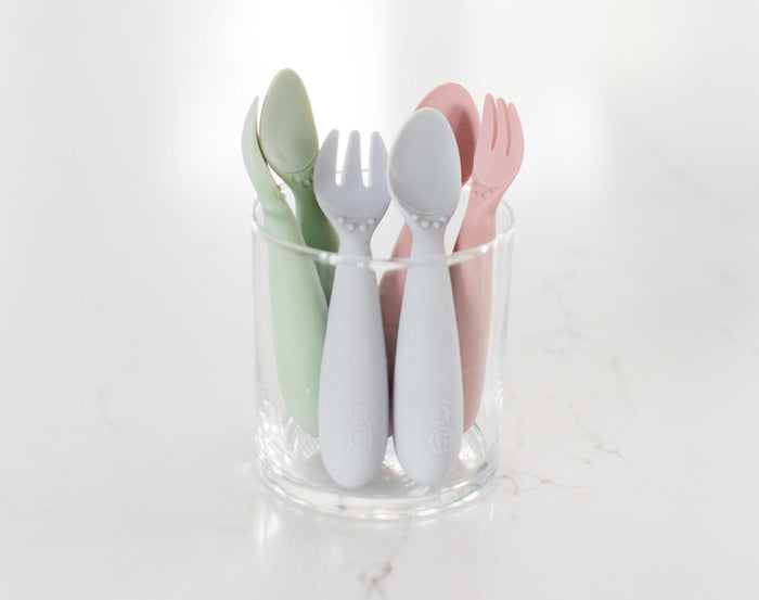 Ezpz Mini Utensils set of 2 inside of drinking glass in different colors- Available at www.tenlittle.com