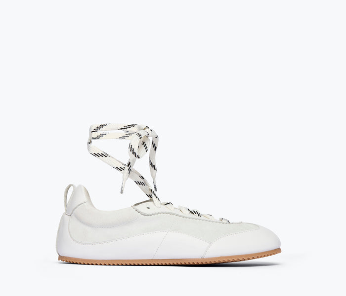 Fred. Salvador Minnie ballet sneaker in milk calf leather with long laces and a sleek, stylish design.