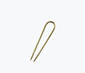 NATALIE BORTON brass French pin accessory with intricate design, displayed on a neutral background.