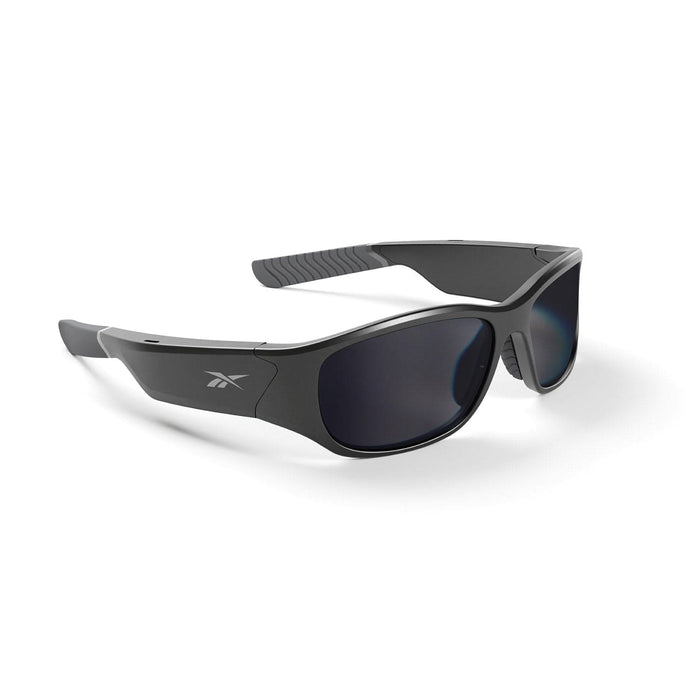 The Reebok Nitrous sunglasses feature a black wraparound design with dark polarized lenses, textured arm grips, and a subtle logo on the side.