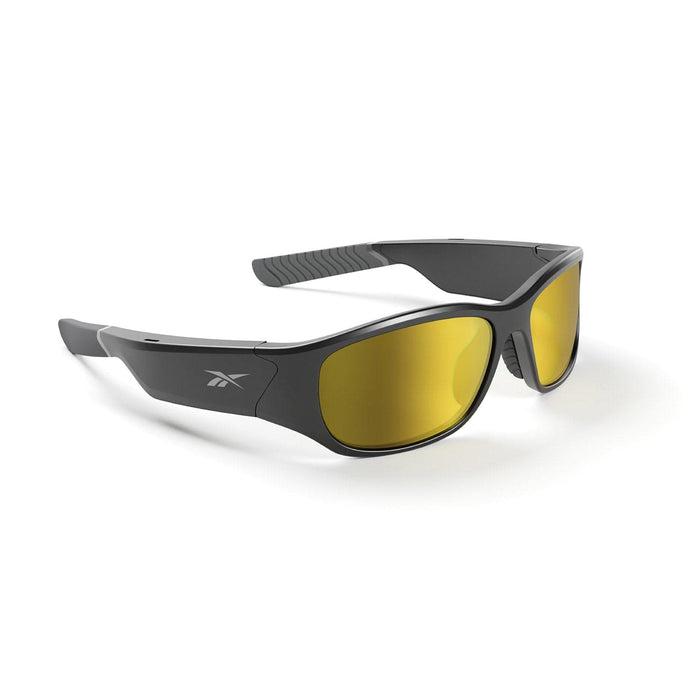 The Reebok Nitrous sunglasses feature a black wraparound design with yellow-tinted polarized lenses, a subtly curved frame, and textured arms. They are displayed on a white surface from an angled side perspective.