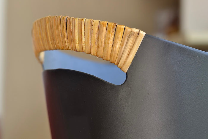 The Ørskov Wastebasket is made in matte black steel with cane wrapped handles and is 13" tall. It was designed by Grethe Kornerup-Bang in Denmark and is still  produced by Torben Orskow. Detail.