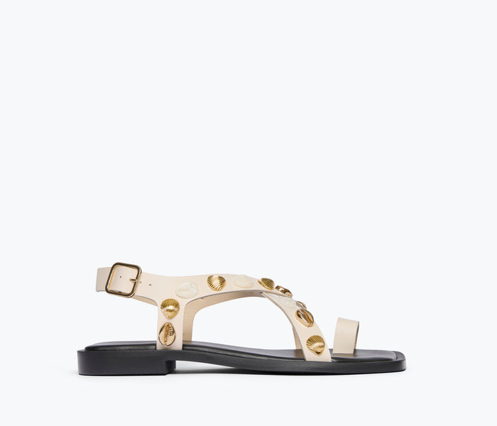 Freda Salvador Paxton sandal in bone color with gold shell accents, front view showing stylish open-toe design and ankle strap.