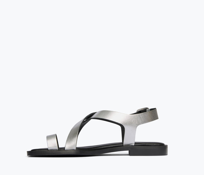 FREDA SALVADOR PAXTON silver sandal showing calf inside view with strap details and metallic finish.