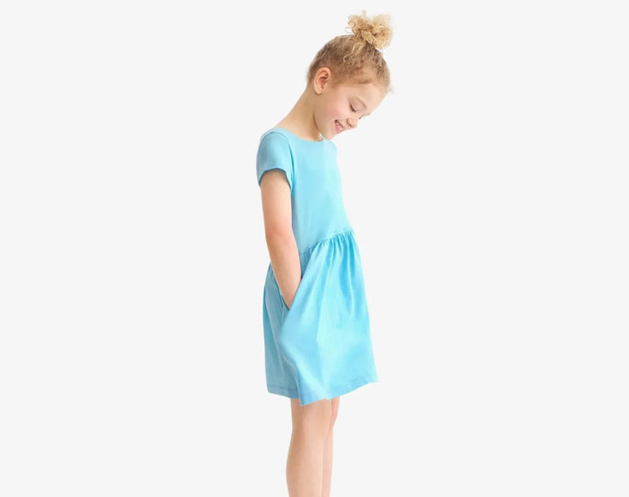 Child with hand in pocket of Primary Pocket Dress - Lagoon. Available at www.tenlittle.com