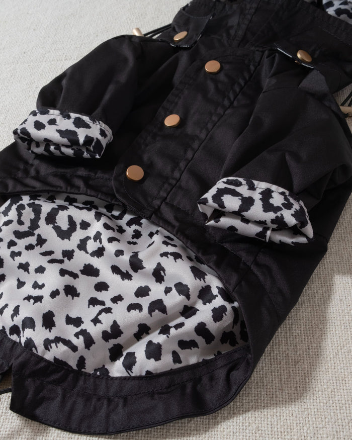black dog raincoat with leopard print lining and removable hood. pug in a raincoat
