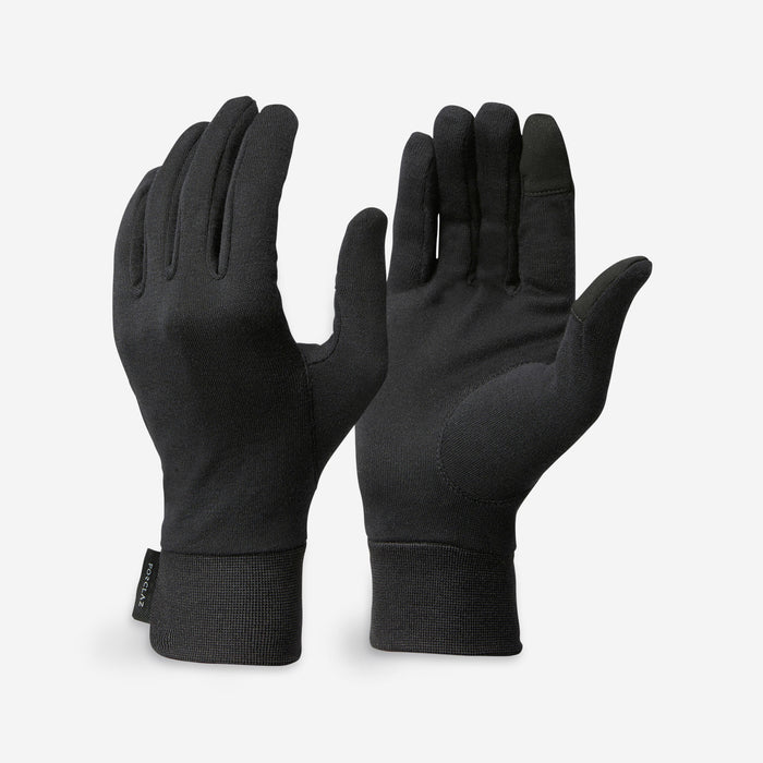 Pair of black gloves on a light gray background