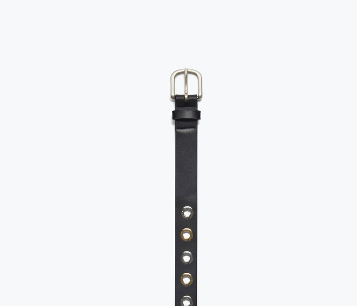 Close-up of FREDA SALVADOR Rebecca Belt with grommets and buckle detail on brown leather strap.