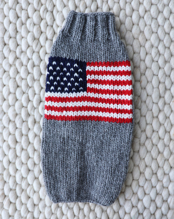 Red, White + Woof American Flag Dog Sweater, patriotic and cozy for small to medium breeds like Pomeranians, Boston Terriers, and Cavaliers.