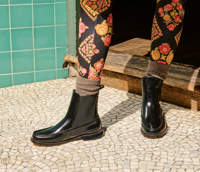 Freda Salvador Renn black moccasin Chelsea boot with elastic side panels and sleek leather design.