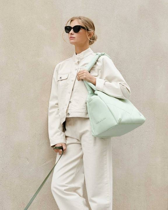 Comfortable mint green pet carrier for dogs like Chihuahuas and Dachshunds on the go.