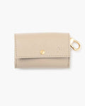Ivory waste bag holder with gold zipper, designed for stylish dog walks