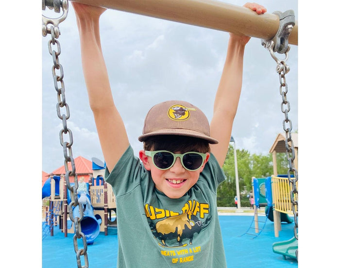 Boy wearing Roshambo Round Sunglasses - Sage Green. Available at www.tenlittle.com