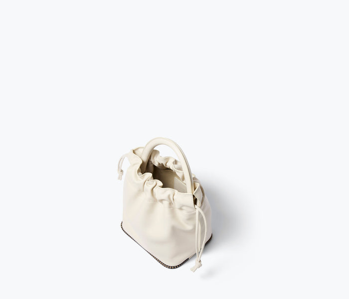 Freda Salvador Ruby Bucket Bag in bone calf leather, showing the interior with spacious compartment and stylish design.