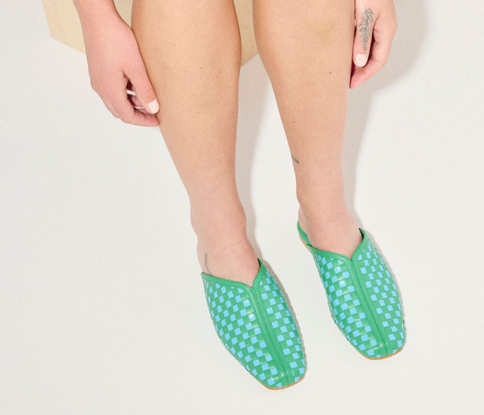 Freda Salvador Saanvi woven leather slide mule in Kelly green and blue with intricate woven pattern.