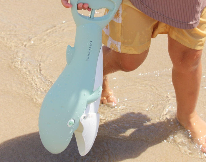 Child holding Sunnylife Sand Claw - Whale. Available at www.tenlittle.com