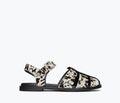 Freda Salvador SERA fisherman sandal in black and white cow print, front view showing stylish strap details and craftsmanship.