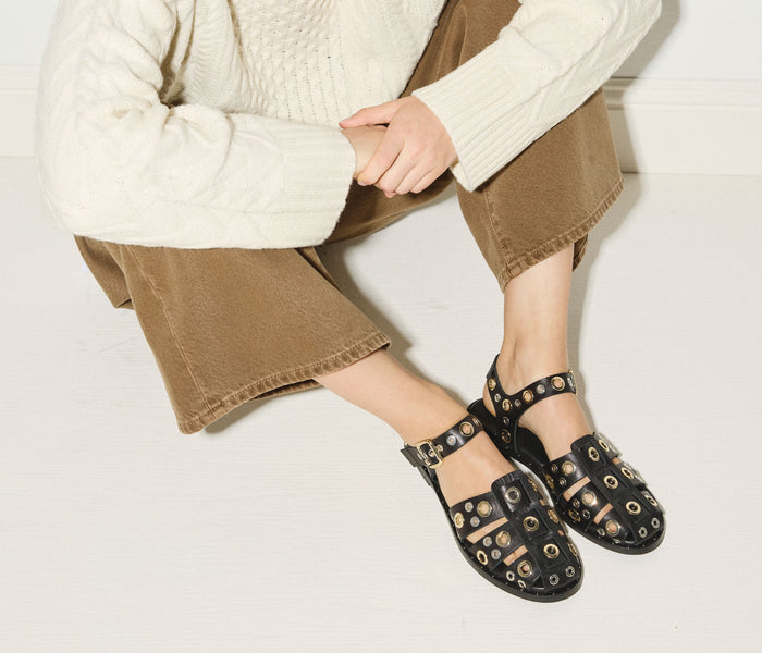 Black SERA Fisherman sandal by FREDA SALVADOR featuring grommet details and a casual, stylish design.