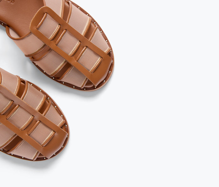 Freda Salvador Sera Fisherman Sandal featuring stone mesh detail and classic sandal design in a natural outdoor setting.