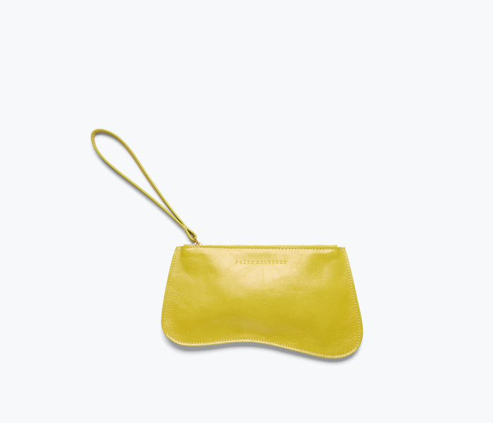 Freda Salvador Serena slip pouch in mustard crinkle calf leather, compact bag with sleek design and gold zipper closure.