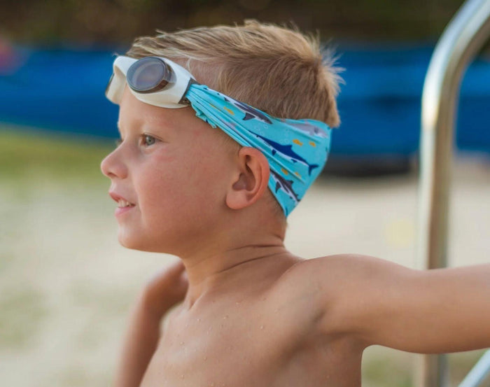 Boy wearing Splash Place Shark Tangle-Free Swim Goggles. Available from www.tenlittle.com