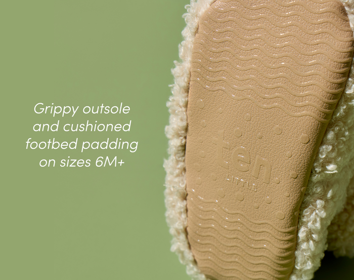 Close-up of grippy outsole and cushioned footbed padding on sizes 6M+ of Ten Little Sherpa Baby Booties. Available at www.tenlittle.com