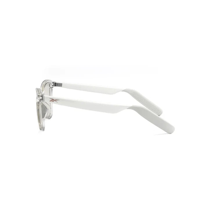 Side view of Reebok Shine smart glasses featuring clear frames, white curved arms with a small silver hinge and subtle metallic accent near the temples, set against a plain white background.