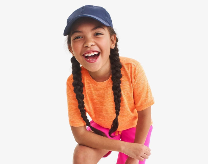 Child wearing Primary StayCool Classic Tee - Cantaloupe. Available at www.tenlittle.com