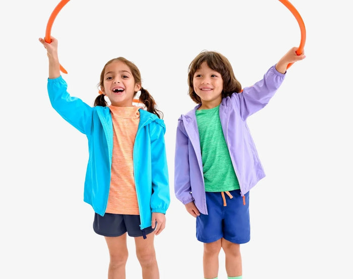 Child playing wearing Primary Running Shorts - Navy. Available at www.tenlittle.com